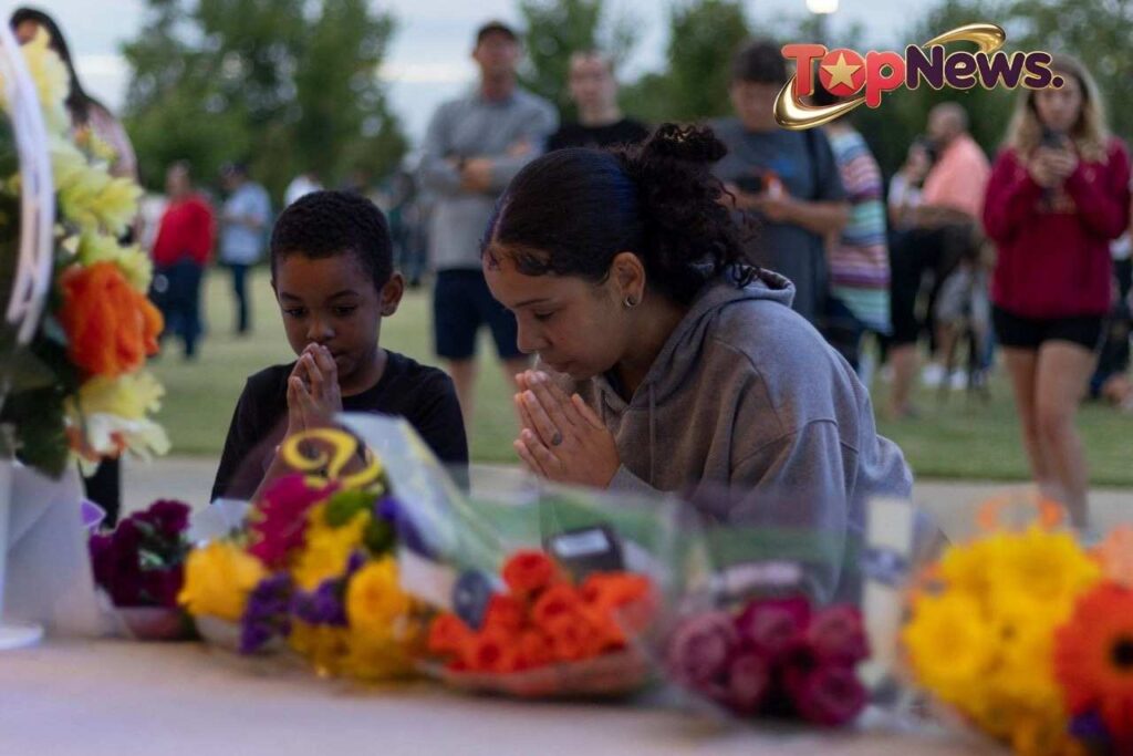People pray during a vigil on Thursday.